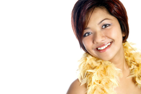 Beautiful young Asian female with feather boa, isolated on white with copyspace.