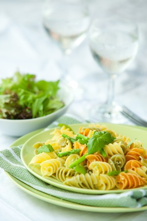 Colorful pasta with asparagus and rocket pesto and basilの写真素材