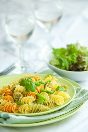 Colorful pasta with asparagus and rocket pesto and basilの写真素材
