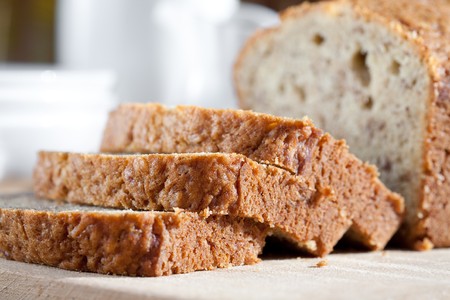 Delicious freshly baked banana bread on wooden boardの写真素材