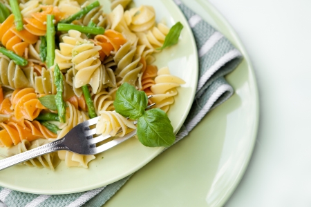 Colorful pasta with asparagus and rocket pesto and basilの写真素材