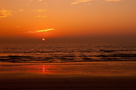 Sun setting over a tropical seaの写真素材