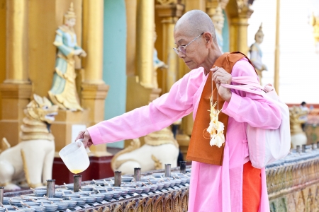 YANGON, MYANMAR - JAN 31  Buddhist devotees lighting candles at the full moon festival, Shwedagon Pagoda, January 31, 2010 in Myanmar  Burma  のeditorial素材