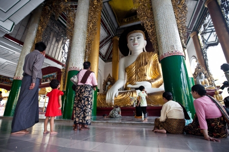 YANGON, MYANMAR - JAN 28  Buddhist devotee praying to statue of Buddha at the full moon festival, Shwedagon Pagoda, January 28, 2010 in Myanmar  Burma  のeditorial素材