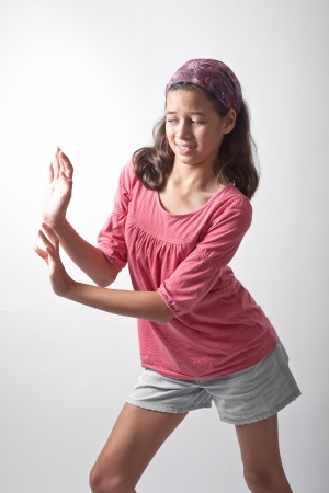 Young girl pushing imaginary wallの写真素材