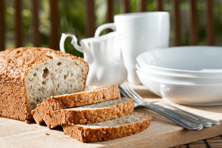 Meal setting with sliced banana bread and serving bowls 