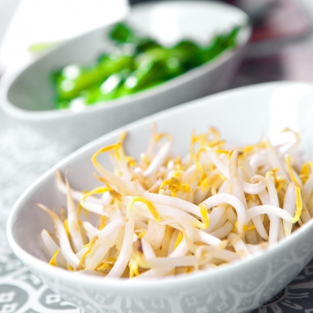Bowls of fresh bean sprouts and steamed baby bokchoi, an oriental vegetable.の写真素材