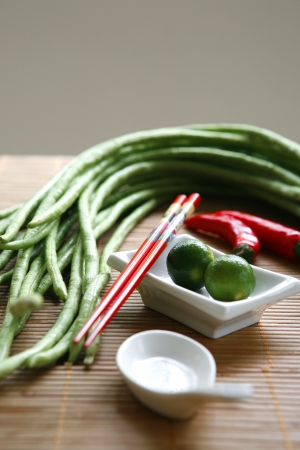 Chinese cooking set with oriental ingredients  of long beans, chili and local limes.の写真素材