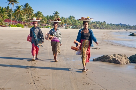 NGWE SAUNG MYANMAR - 2ND FEBRUARY. Three local Burmese women selling grilled fish to visitors along the beach of Ngwe Saung, Myanmar 2nd February 2010. The west coast of Myanmar's boast the most  beautiful sandy beaches and very popular amongst locals andのeditorial素材