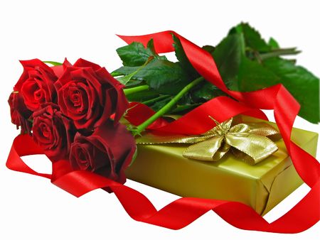 Scarlet roses with a golden gift box on the white background.の写真素材