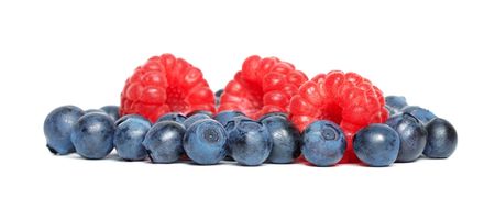Ripe blueberries and raspberries isolated on the white background.の写真素材