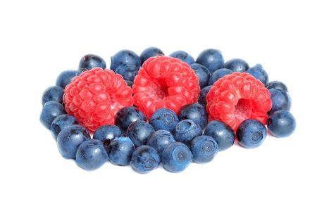 Ripe blueberries and raspberries isolated on the white background.の写真素材