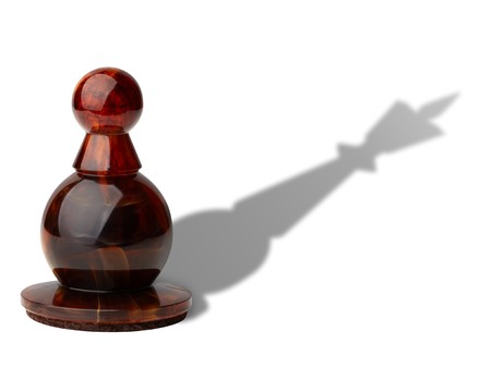 Chess pawn with king's shadowの写真素材