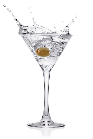 Splash from olive in a glass of cocktail, isolated on the white backgroundの写真素材