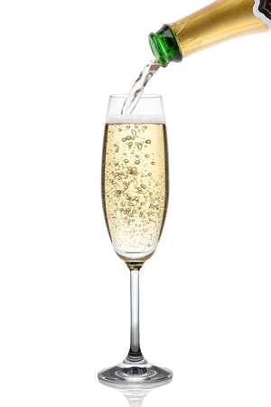 Champagne pouring into a glass, isolated on the white background, clipping path included の写真素材