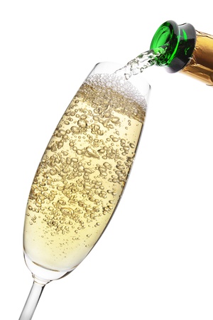 Champagne pouring into a glass, isolated on the white background, clipping path included の写真素材