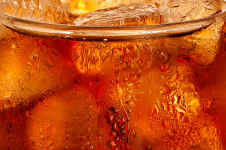 Closeup of cola with ice cubes in the glass の写真素材