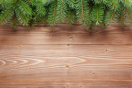 Christmas tree branches on wooden surface. Holiday background.の写真素材