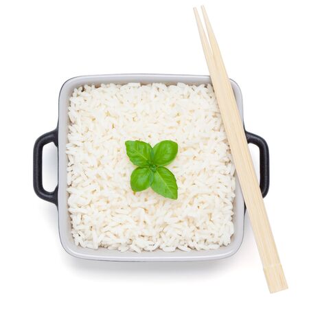 Rice with basil in ceramic bowl with wooden chopsticks, isolated on the white background, clipping path included.の写真素材