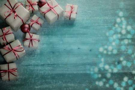 Christmas background with decorations and gift boxes on wooden boardの写真素材