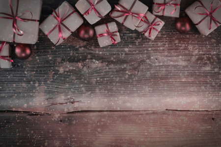 Christmas background with decorations and gift boxes on wooden boardの写真素材