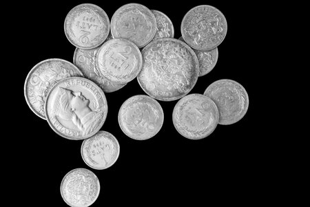 Old Latvian lats silver coin stack isolated on black