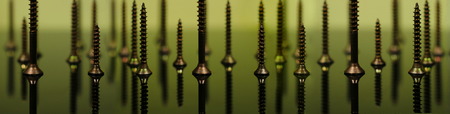 Screws macro photo, yellow background, metal screwの写真素材