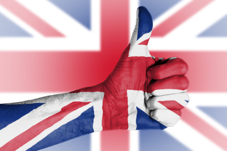 Brexit result - Thumbs up in front of Union Jack flagの写真素材