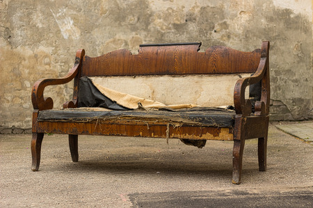 Vintage old grungy ripped abandoned couch, sofaの写真素材
