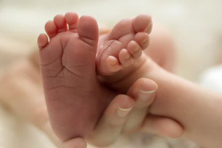 Baby legs. Legs newborn in parents hand