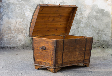 Old grungy wooden treasure chest with rusty metal decoration Antique wood and glass book case cabinetの写真素材