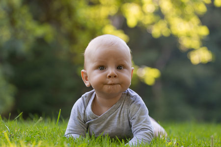 A surprised baby is crawling on the summer