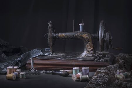 The sewing machine and accessories - threads, needle, scissors, measuring tape.の写真素材