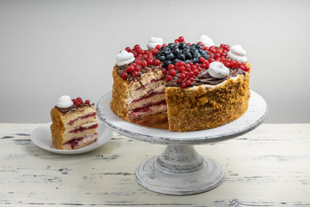 Multi-layered honey and cheesecake with fresh berries.