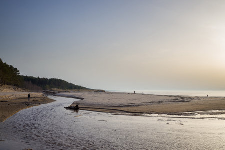 Dramatic landscape with a river winding through a sandy expanse towards the sea. Tranquil and serene...