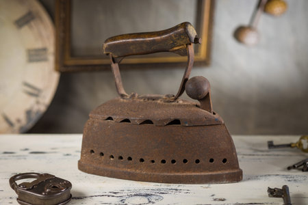 Rusty Vintage Iron with Wooden Handle Sitting on old Table