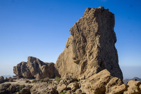 Roque Nublo, an iconic rock formation in Gran Canaria. Dramatic mountain landscape with a clear blue sky. Popular tourist destination. Perfect for nature, travel, or landscape projectsの写真素材