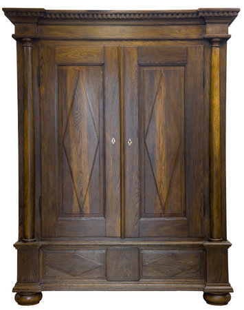 This 18th century oak wardrobe showcases masterful craftsmanship with its polished surface, decorative diamond patterns, and robust columns. A fine example of historical furniture design.の写真素材