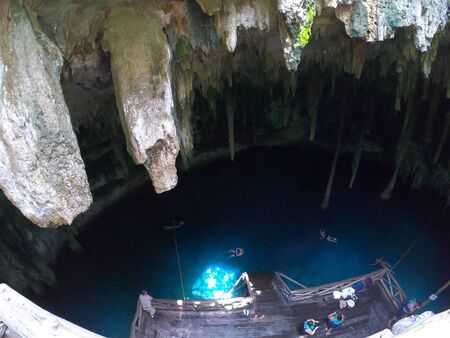 Cenote in Yucatan, Mexico with blue water and stalagmites in the caveの写真素材