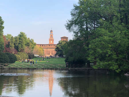 Sempione park with the castle at the back and some trees and a lake in Milan, Italyのeditorial素材