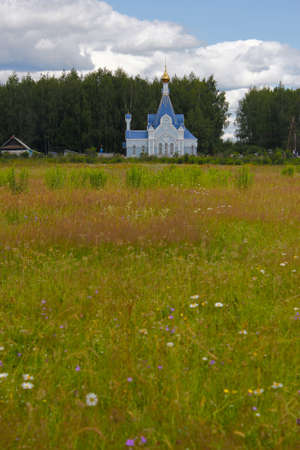 field in front of a rural Orthodox chapelの写真素材