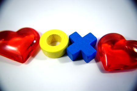 an X and O symbolising hugs and kisses surrounded by two heartsの写真素材