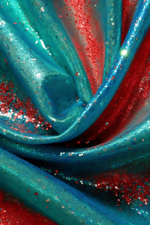 Texture, background, pattern. Silk fabric with sequins in blue and redの素材