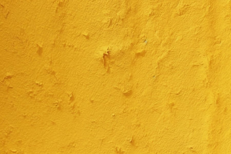Yellow concrete wall texture. Abstract background for design with copy space for text or image.の素材