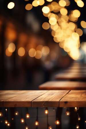 Wooden table in front of blurred background of cafe with bokeh lightsの素材