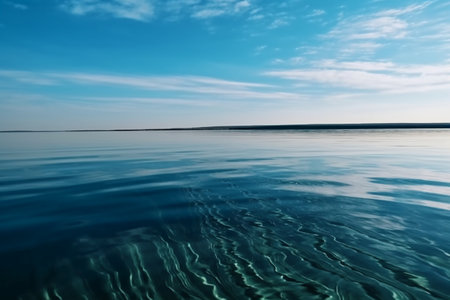blue sky with clouds reflected in calm water of lake, nature seriesの素材