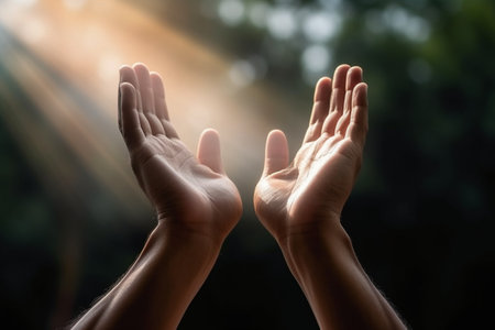 Close up of hands of man and woman praying together with sunlight backgroundの素材