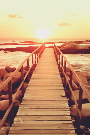 Wooden walkway on the beach at sunset time, vintage toneの素材