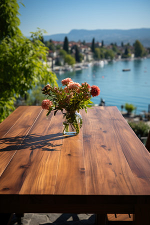 Wooden table and vase with flowers on the background of Lake Como, Italyの素材