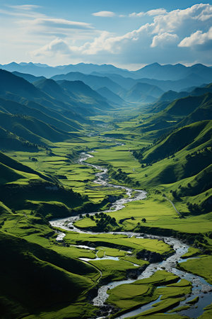 Beautiful landscape of green mountains and river in the valley under blue skyの素材